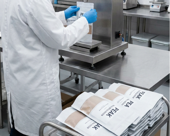 Person in a laboratory setting with medical equipment and supplies.